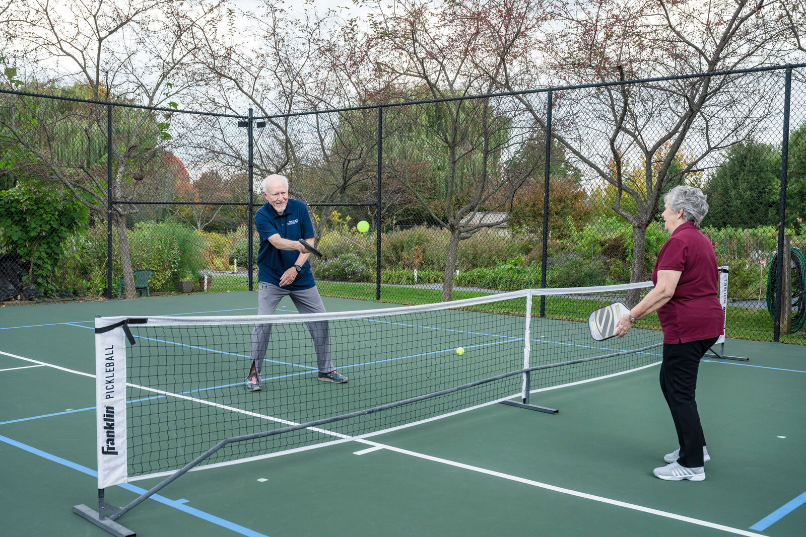 older couple playing pickleball