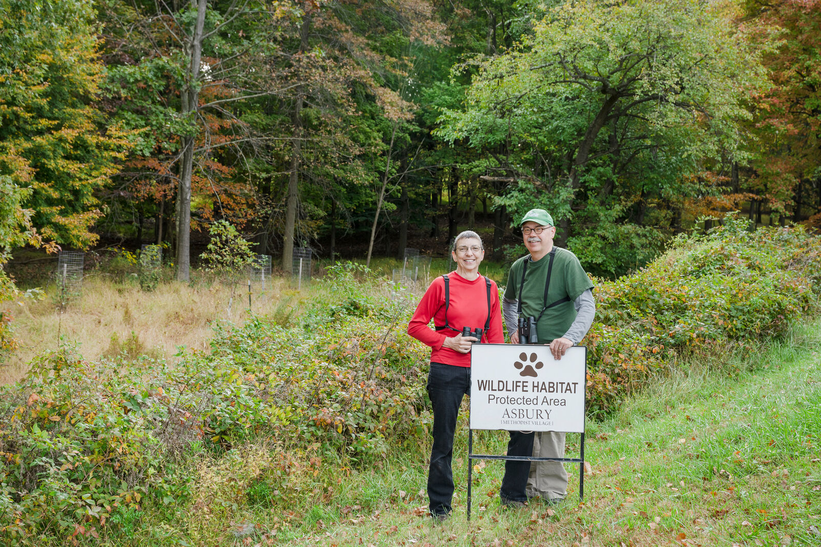 couple standing in nature preserve next to a 