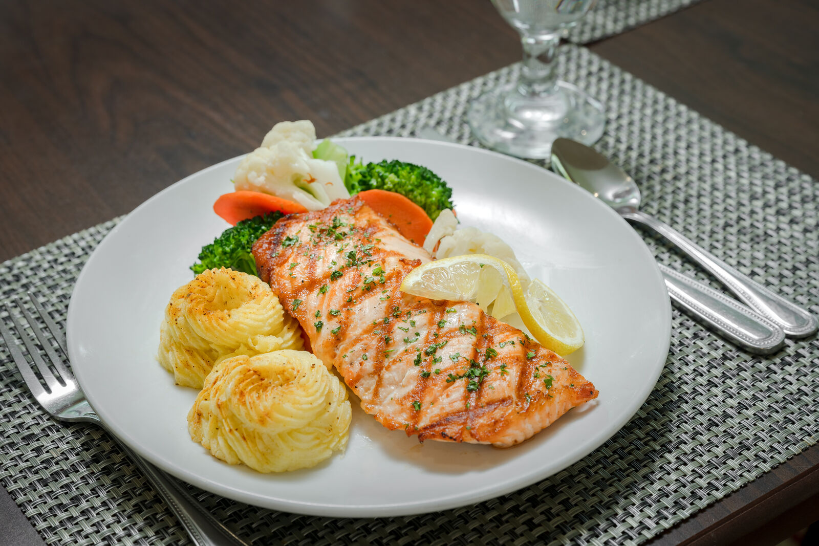 a plate filled with salmon and potatoes