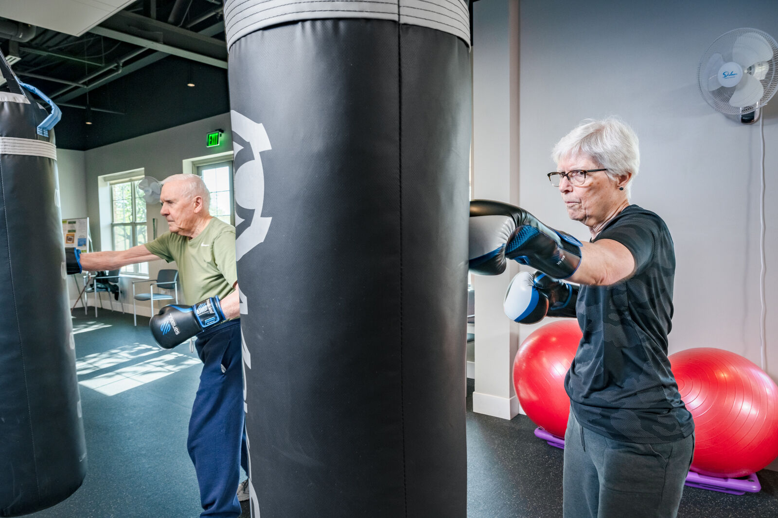 older man and woman boxing