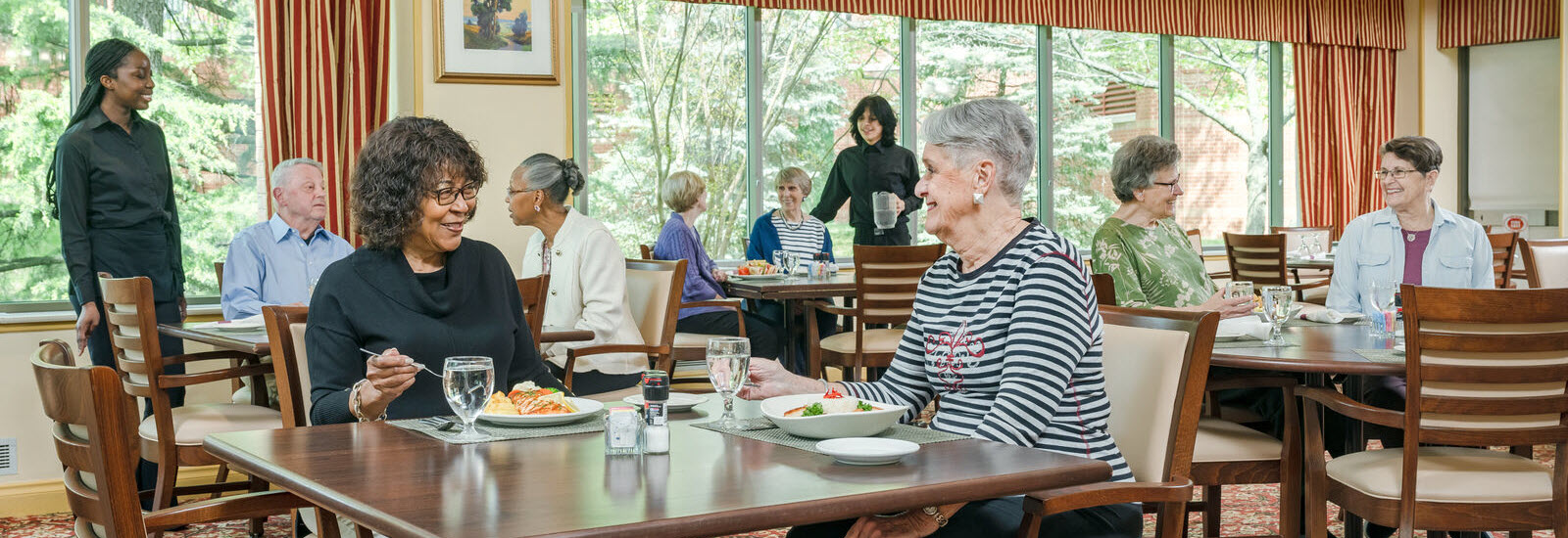 residents eat dinner and visit with each other at the Hefner Dining Room