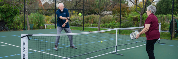 male senior resident and female senior resident playing pickle ball